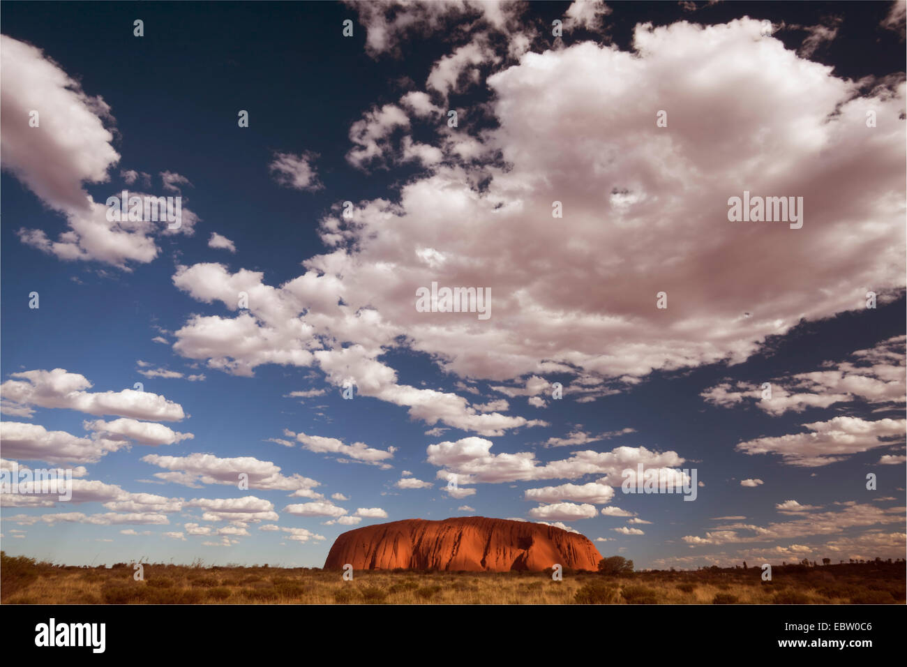 clouds over Ayers Rock, Australia, Northern Territory, Uluru-Kata Tjuta National Park Stock Photo