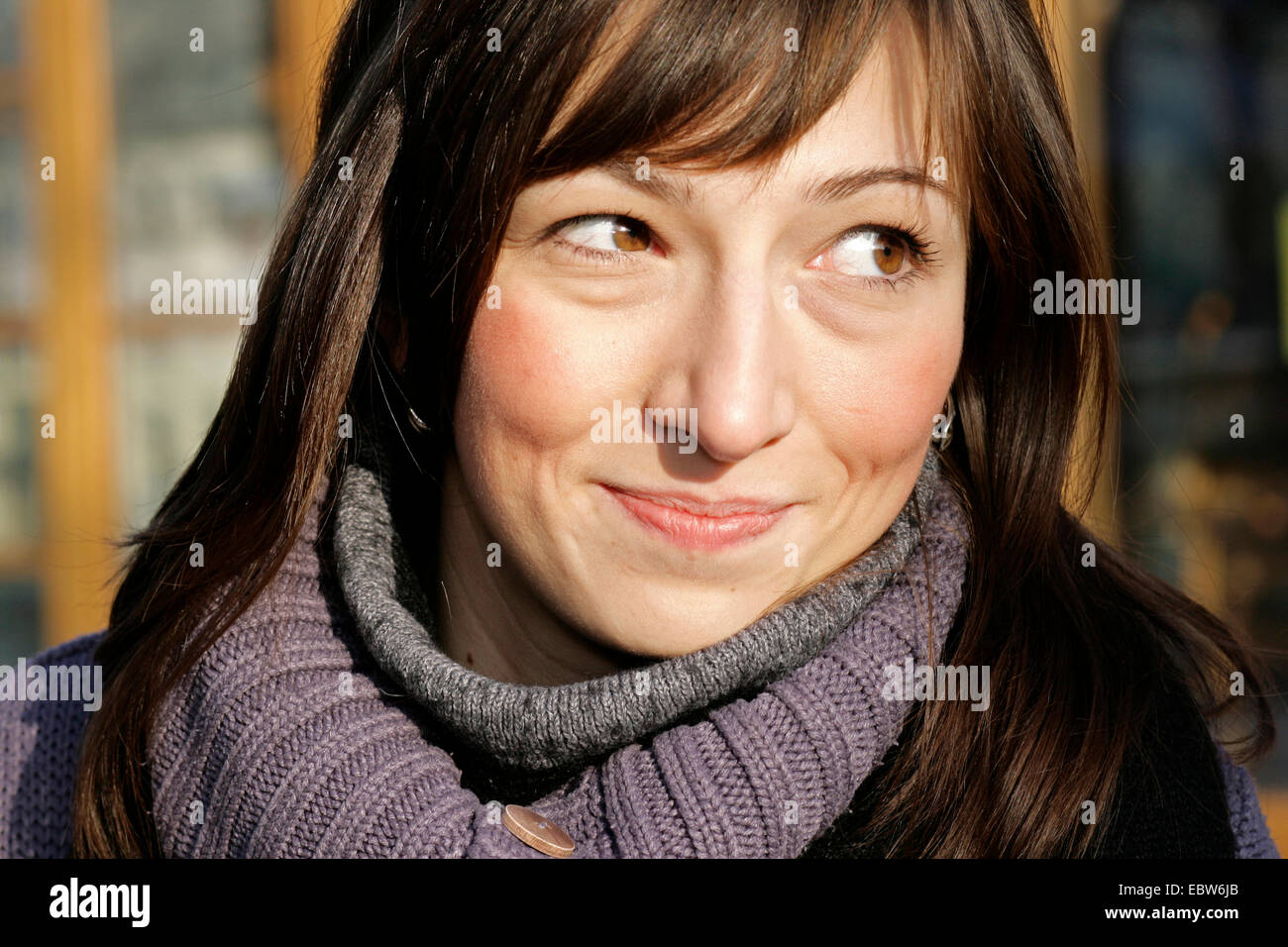 impish sideglance of abrown-haired woman, portrait, Germany Stock Photo