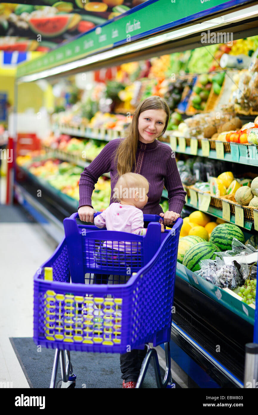 a young mother with baby shopping in a supermarket Stock Photo Alamy