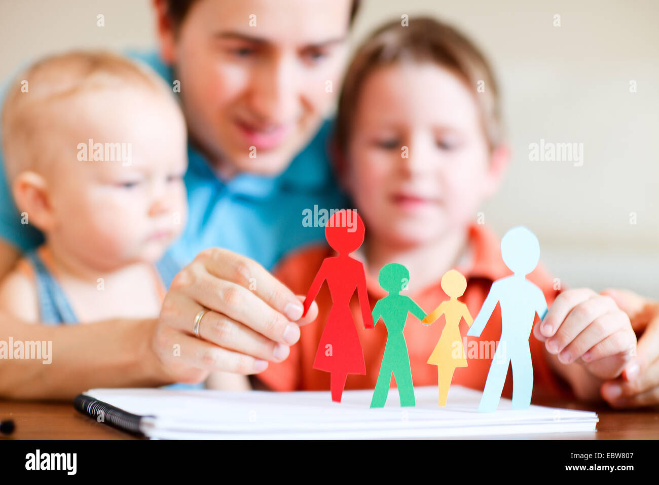 a father playing with his two children Stock Photo