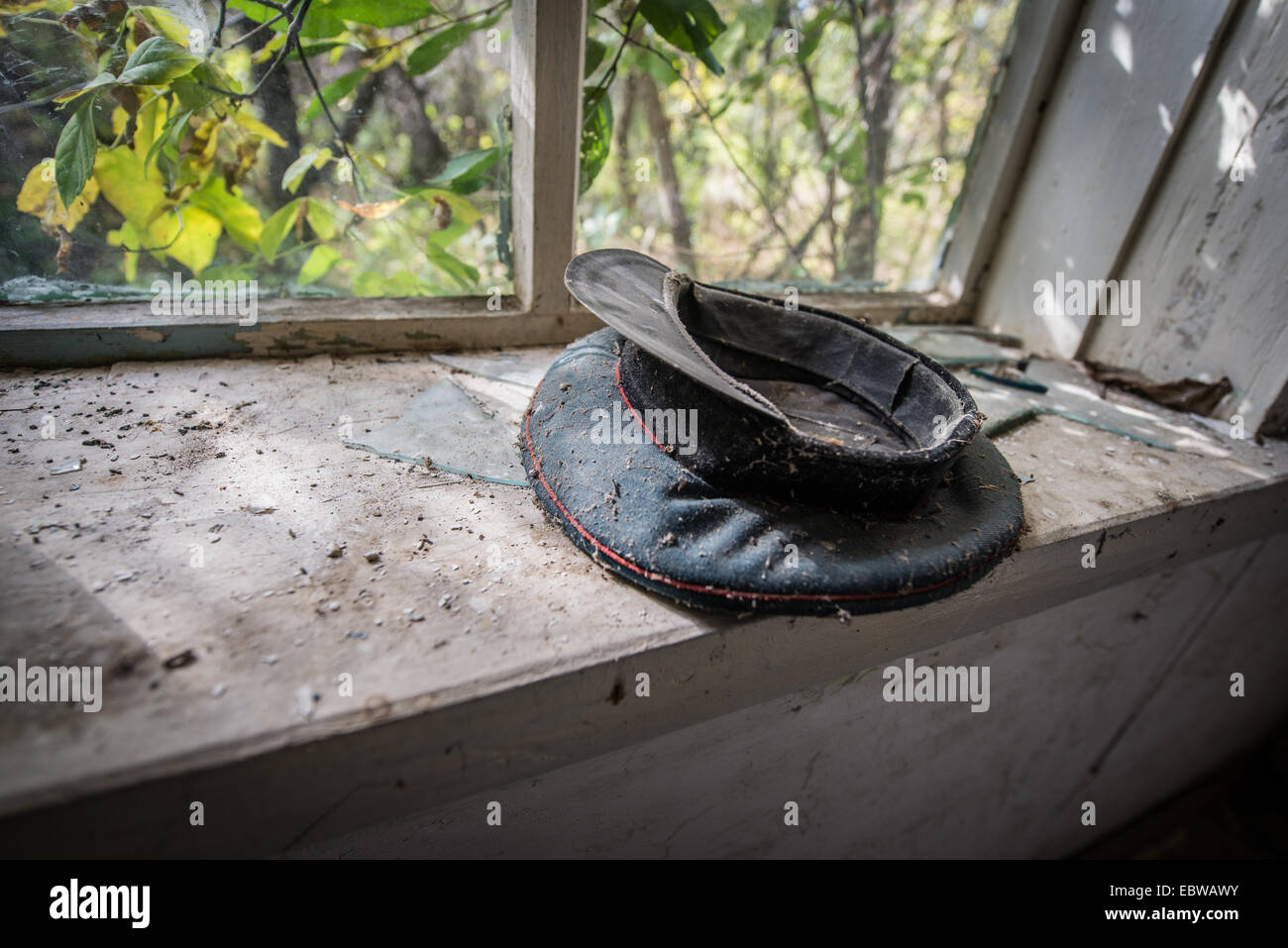 peaked cap in old wooden cottage in abandoned Stechanka village, Chernobyl Exclusion Zone, Ukraine Stock Photo