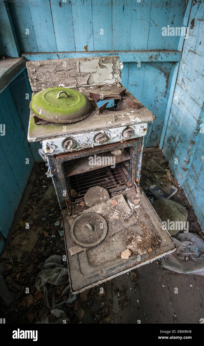 old cooker in wooden cottage in abandoned Stechanka village, Chernobyl Exclusion Zone, Ukraine Stock Photo