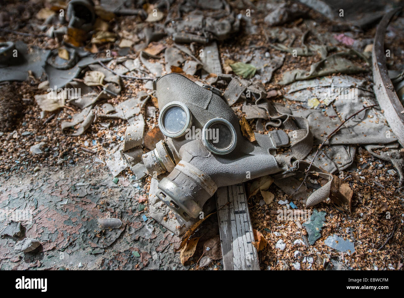 old gas mask from cold war period in abandoned school in Illinci (or Ilintsy) village, Chernobyl Exclusion Zone, Ukraine Stock Photo