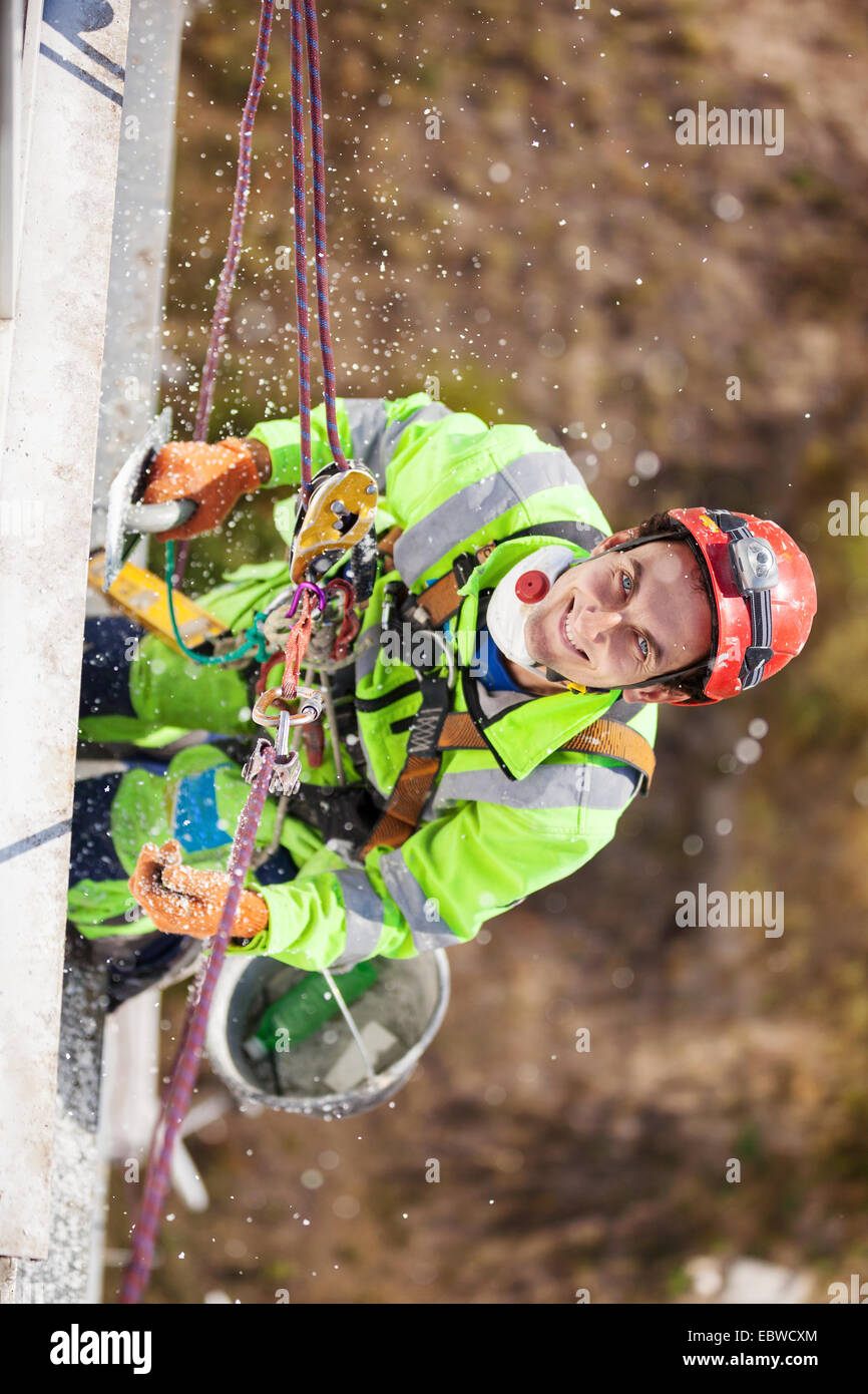 Industrial climber on a building during winterization works Stock Photo ...