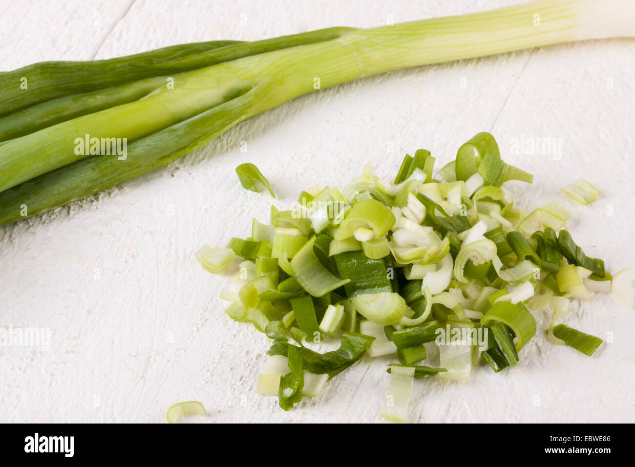 Overhead view of a bunch of fresh leafy leeks or scallions lying on ...