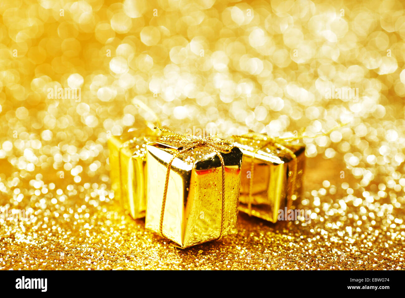 Gold decorative boxes with holiday gifts on abstract gold background ...