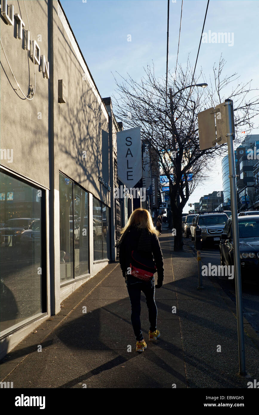 Woman from behind walking down south Granville Street, Vancouver, British Columbia, Canada Stock Photo