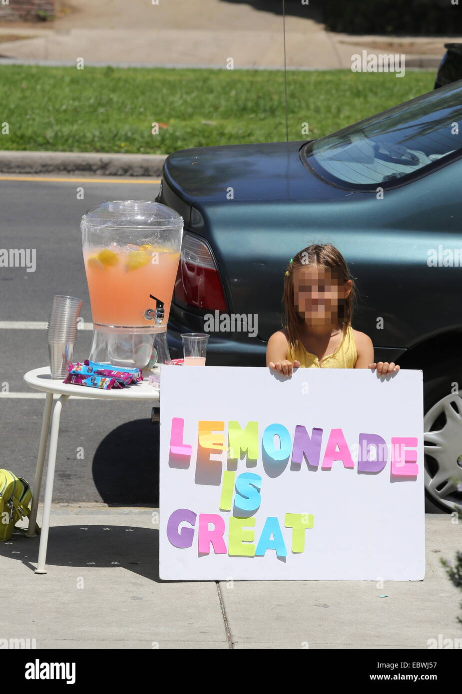 Alessandra Ambrosio watches her daughter Anja sell home made lemonade on a street in Brentwood  Featuring: Anja Mazur Where: Los Angeles, California, United States When: 01 Jun 2014 Stock Photo