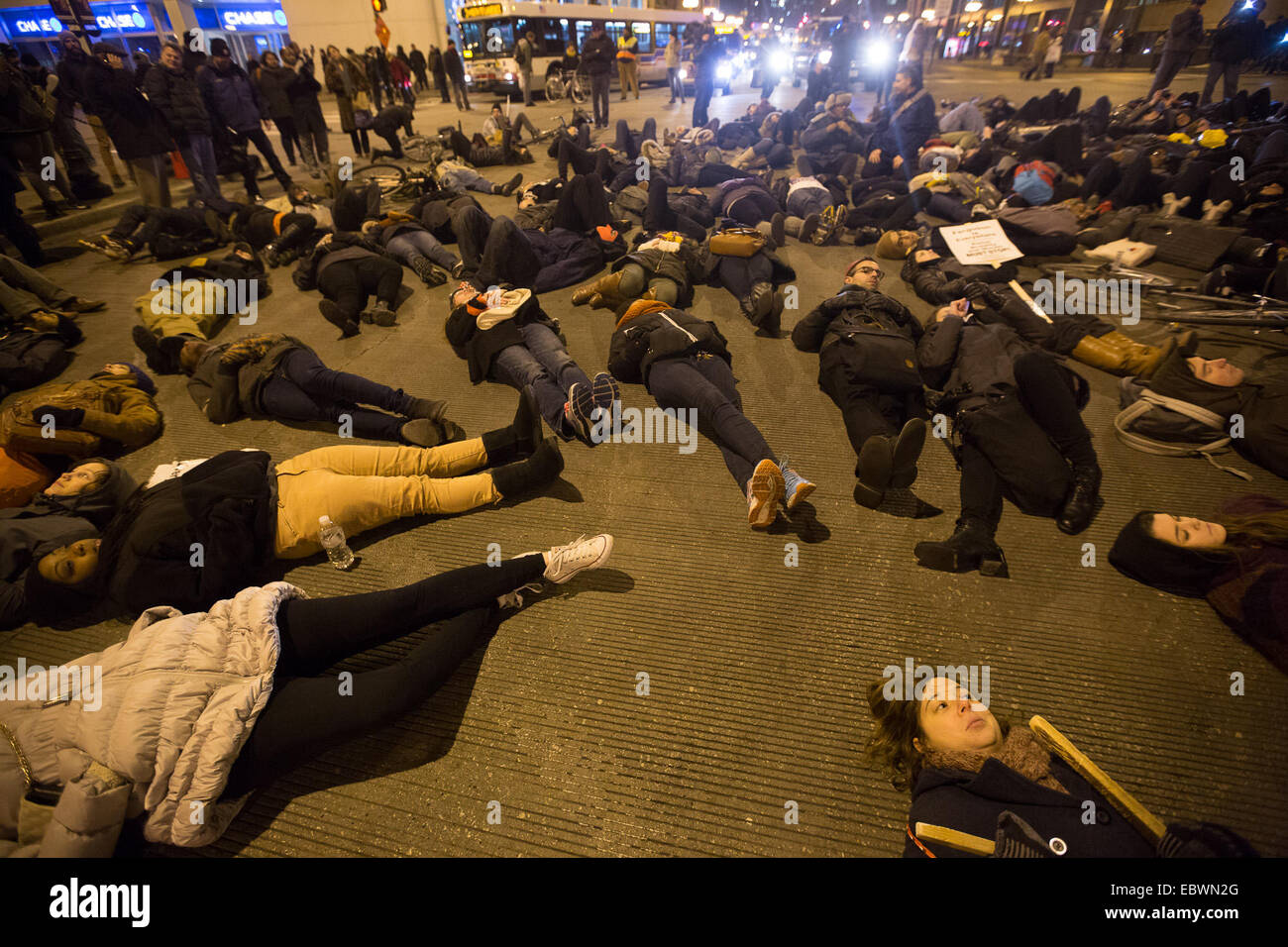 Chicago, Illinois, USA. 4th December, 2014. Protesters lie on a street of Chicago, the United States, to demonstrate concerns over the chokehold death of a black man caused by a white police officer of the New York City Police Department. Eric Garner, a 43-year-old father of six, died in July 17 after police officers attempted to arrest him for allegedly selling loose, untaxed cigarettes on Staten Island, New York. Credit:  Xinhua/Alamy Live News Stock Photo