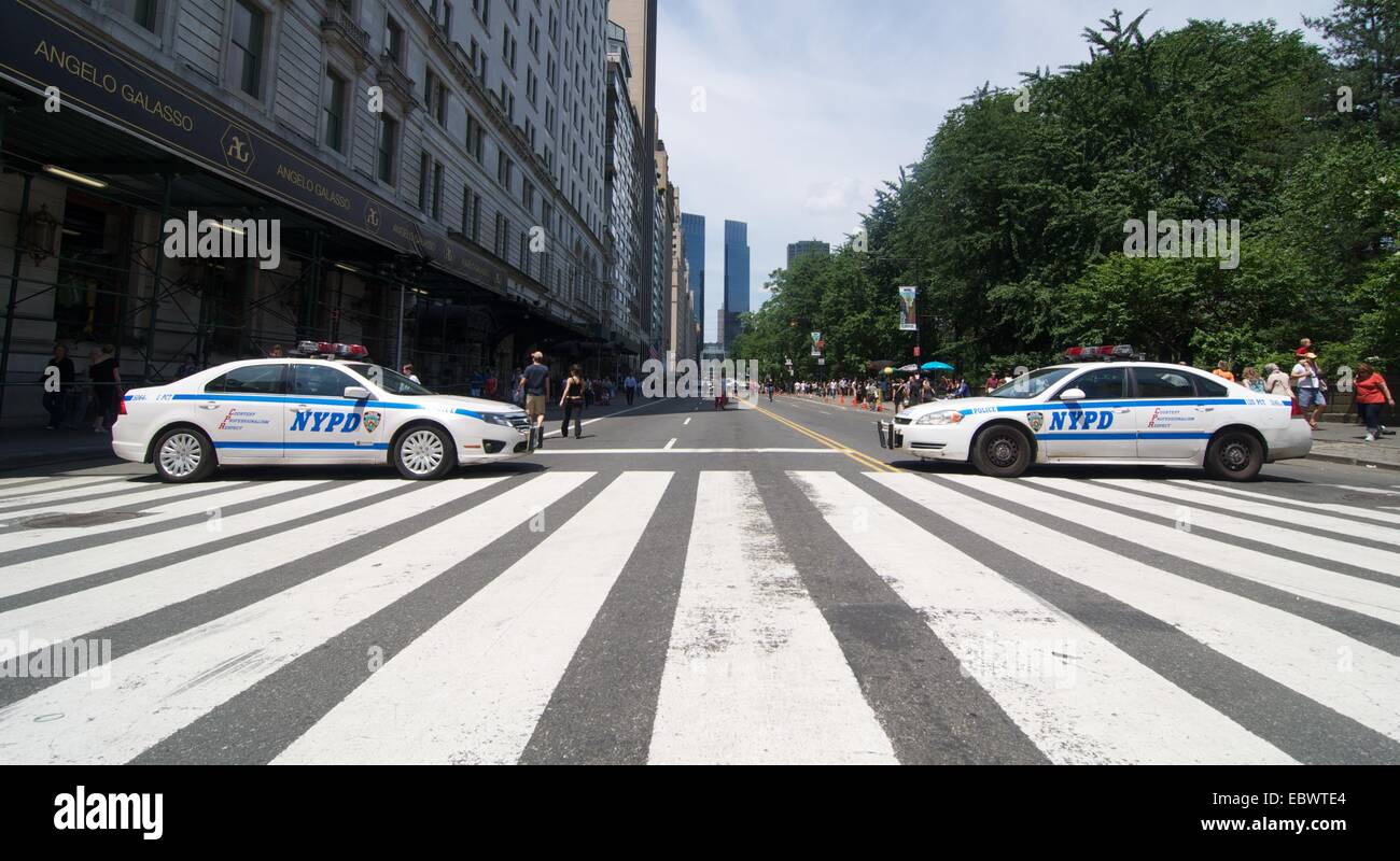 Two NYPD patrol cars block a street in New York City with a crossing in ...