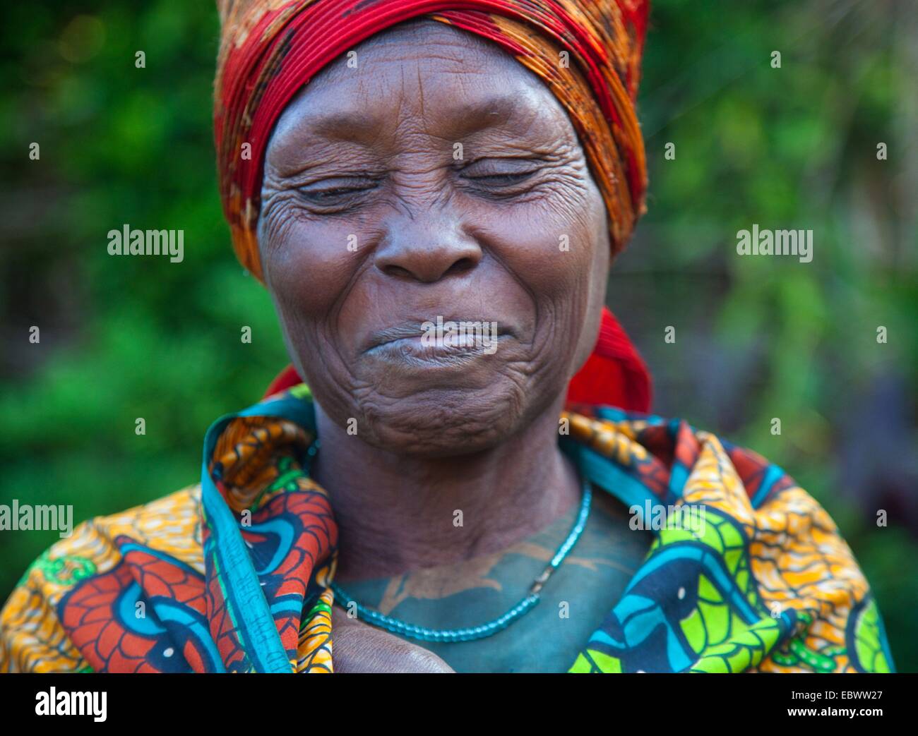 portrait of a smiling woman suspected of being a witch in her village, Burundi, Near National Parc de la Ruvubu, Cankuzo Stock Photo