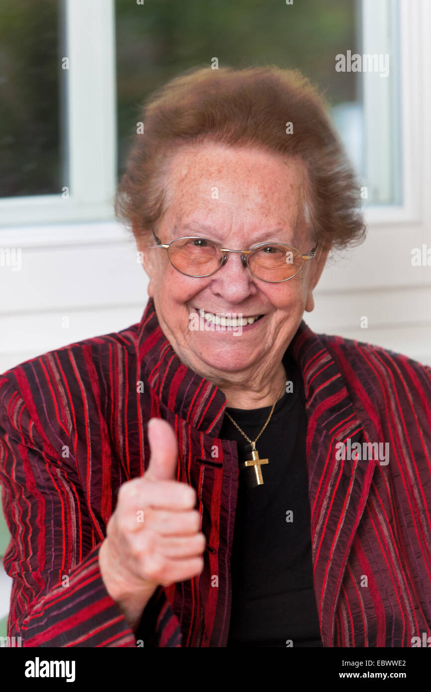 old woman with a smile and the thumb turned up Stock Photo