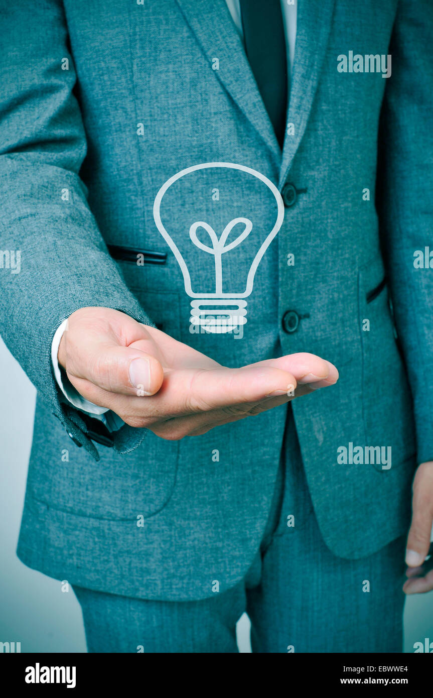 a man wearing a suit with a lightbulb drawn in his hand Stock Photo