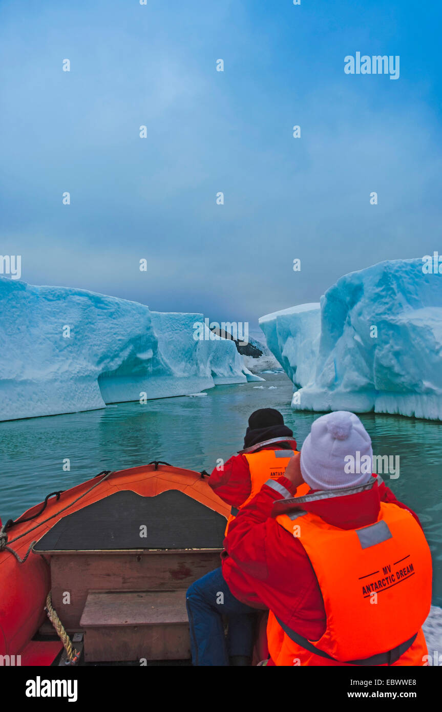 passengers in rubber boat exploring icebergs, Antarctica, Pleneau Island Stock Photo