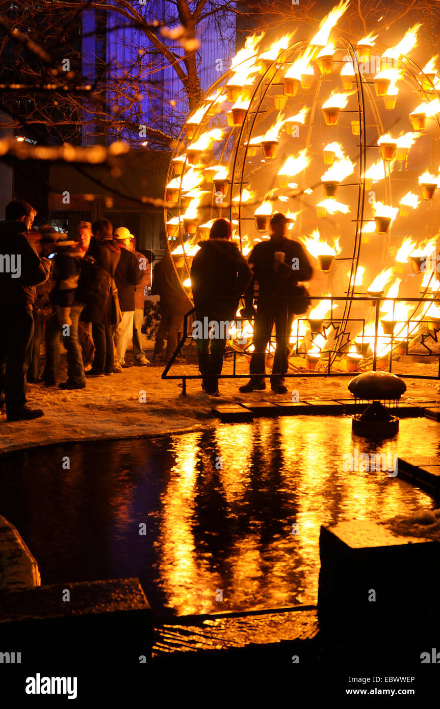 people watching burning globe at a winter event, Canada, Ontario, Toronto Stock Photo