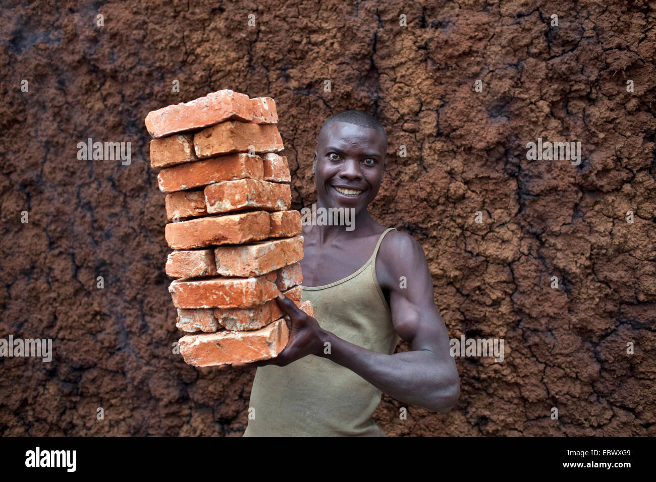 young-man-carrying-stack-of-bricks-burundi-karuzi-buhiga-EBWXG9.jpg
