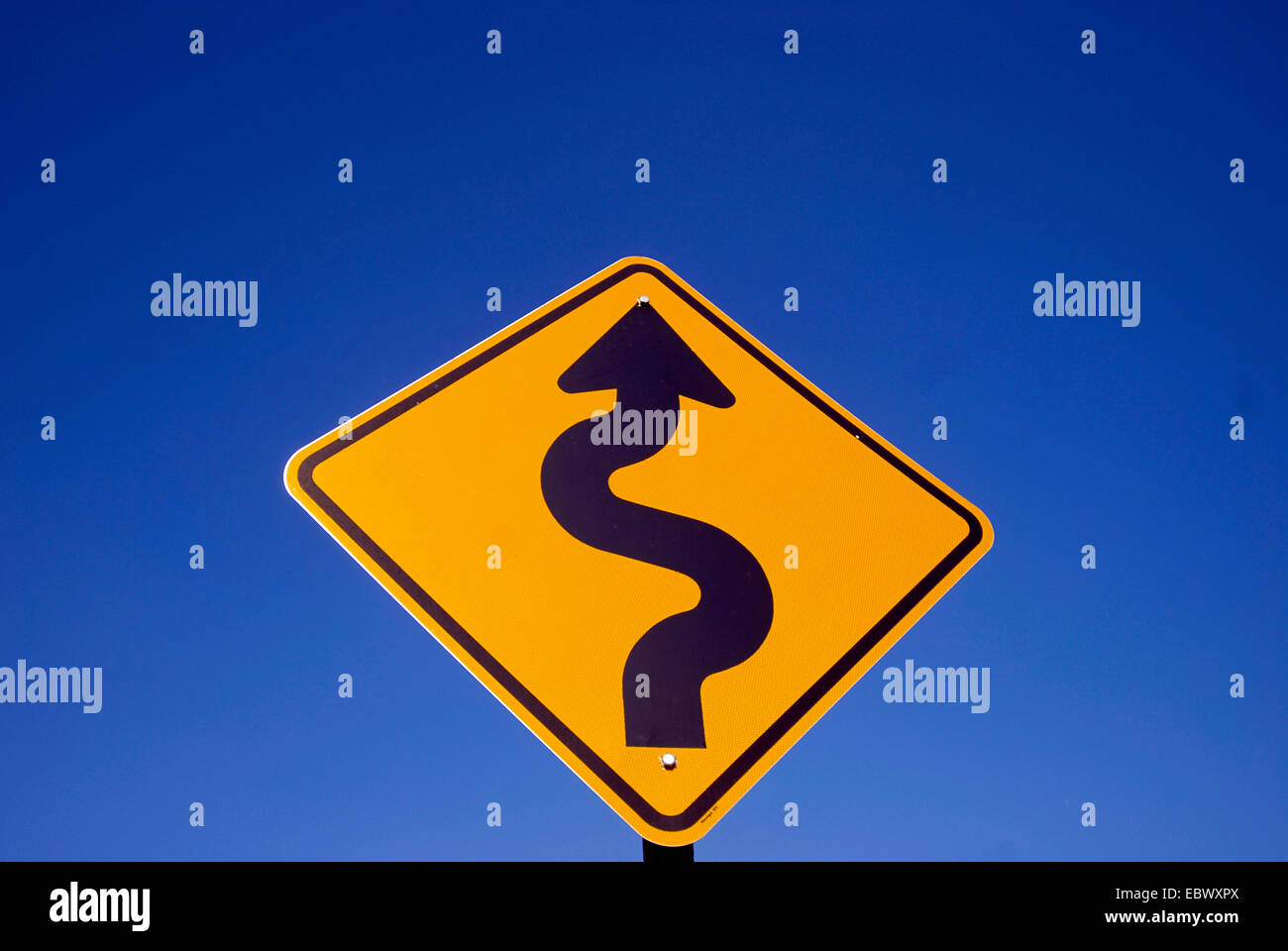 street sign in outback, curvaceous road, Australia Stock Photo