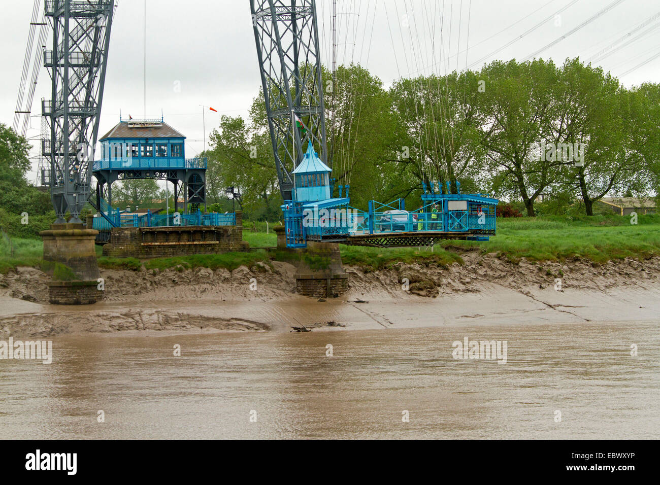 Historic Newport transporter bridge with gondola suspended from immense web of cables carrying vehicles over River Usk in Wales Stock Photo