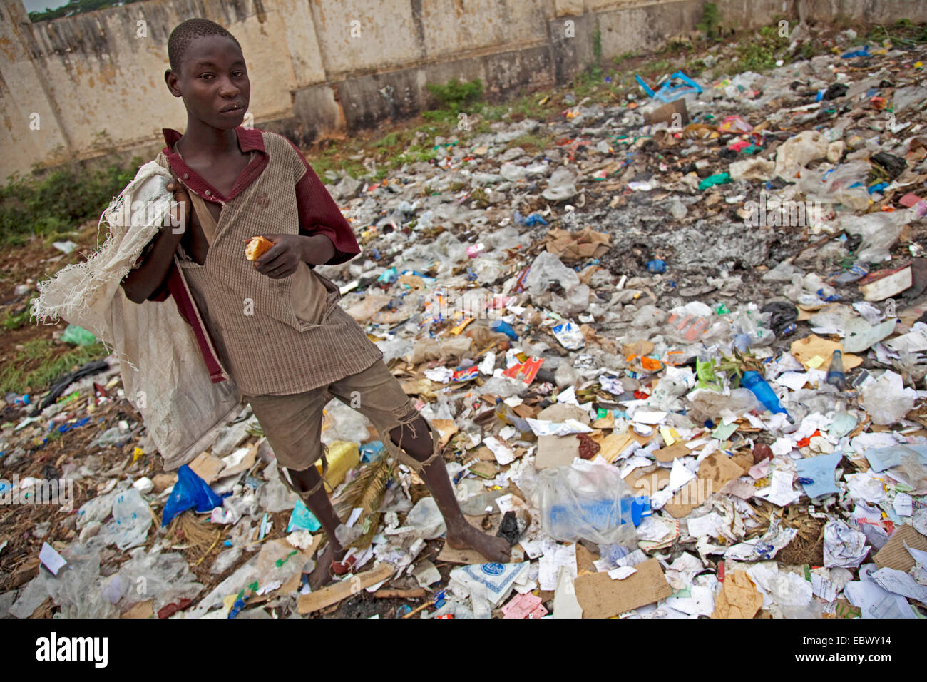 young man is searching for food on an informal wasteyard in the capital