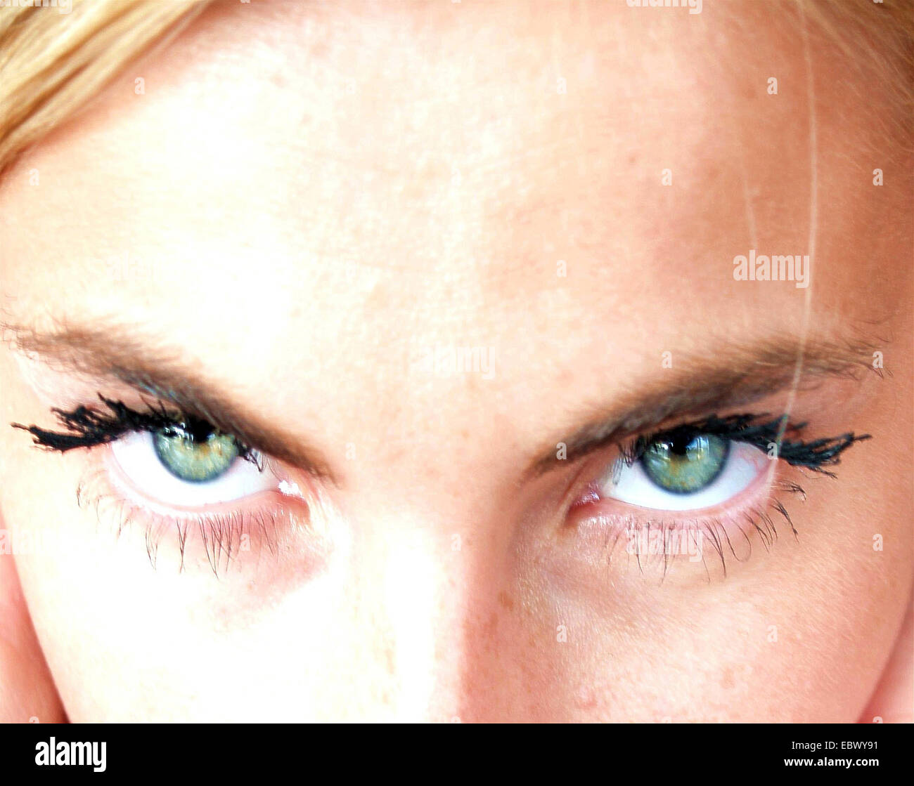 styled pair of cyan-coloured eyes of a blonde young woman Stock Photo