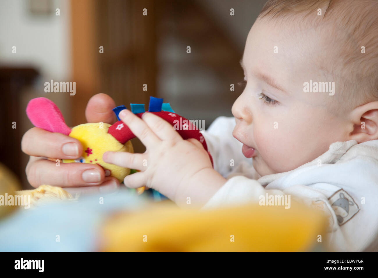 5 months old baby playing with toys Stock Photo