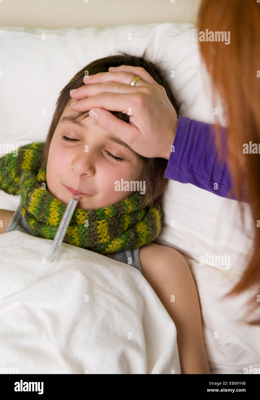 mother with her sick at the bed Stock Photo