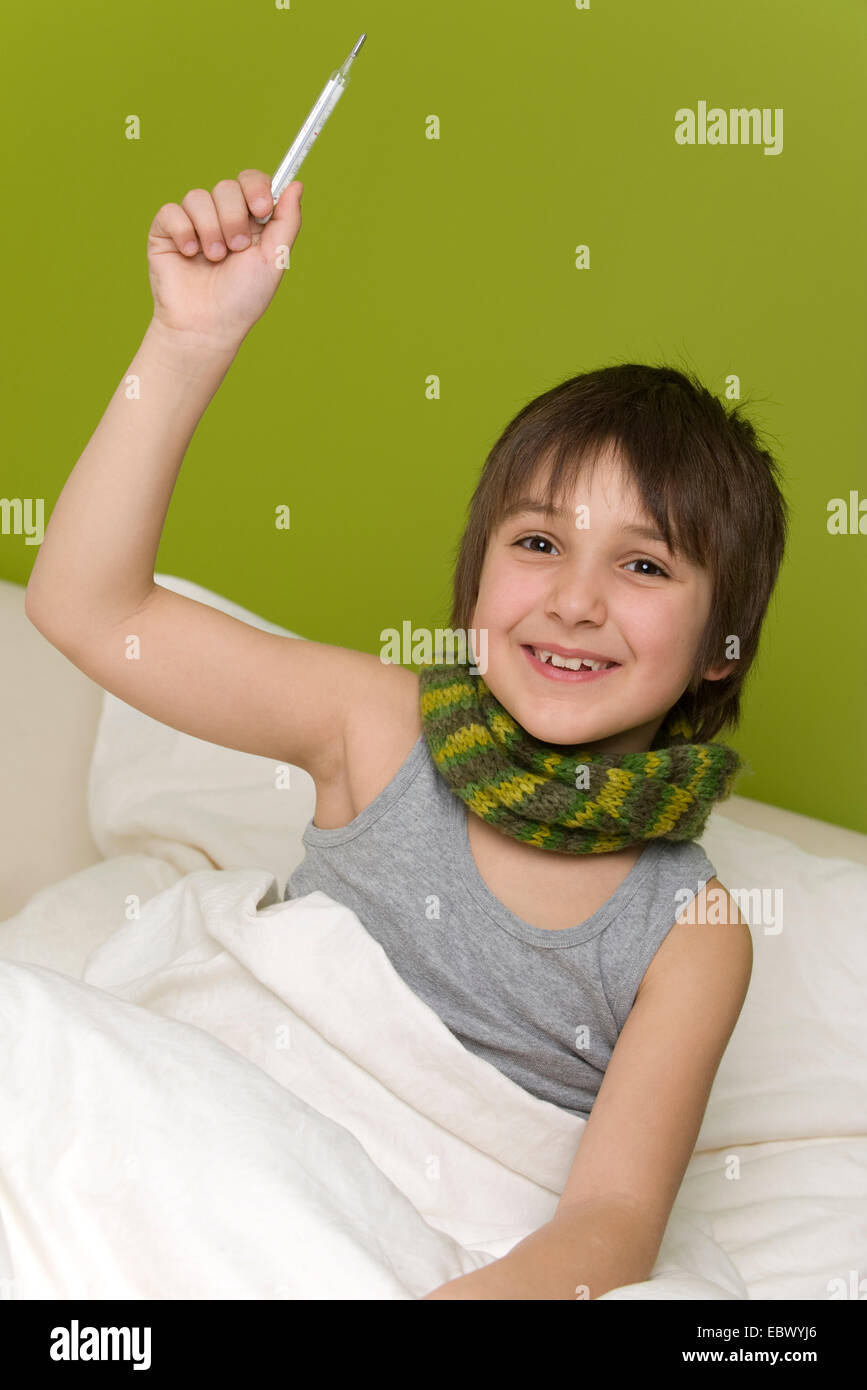 boy with thermometer in his hand getting well Stock Photo
