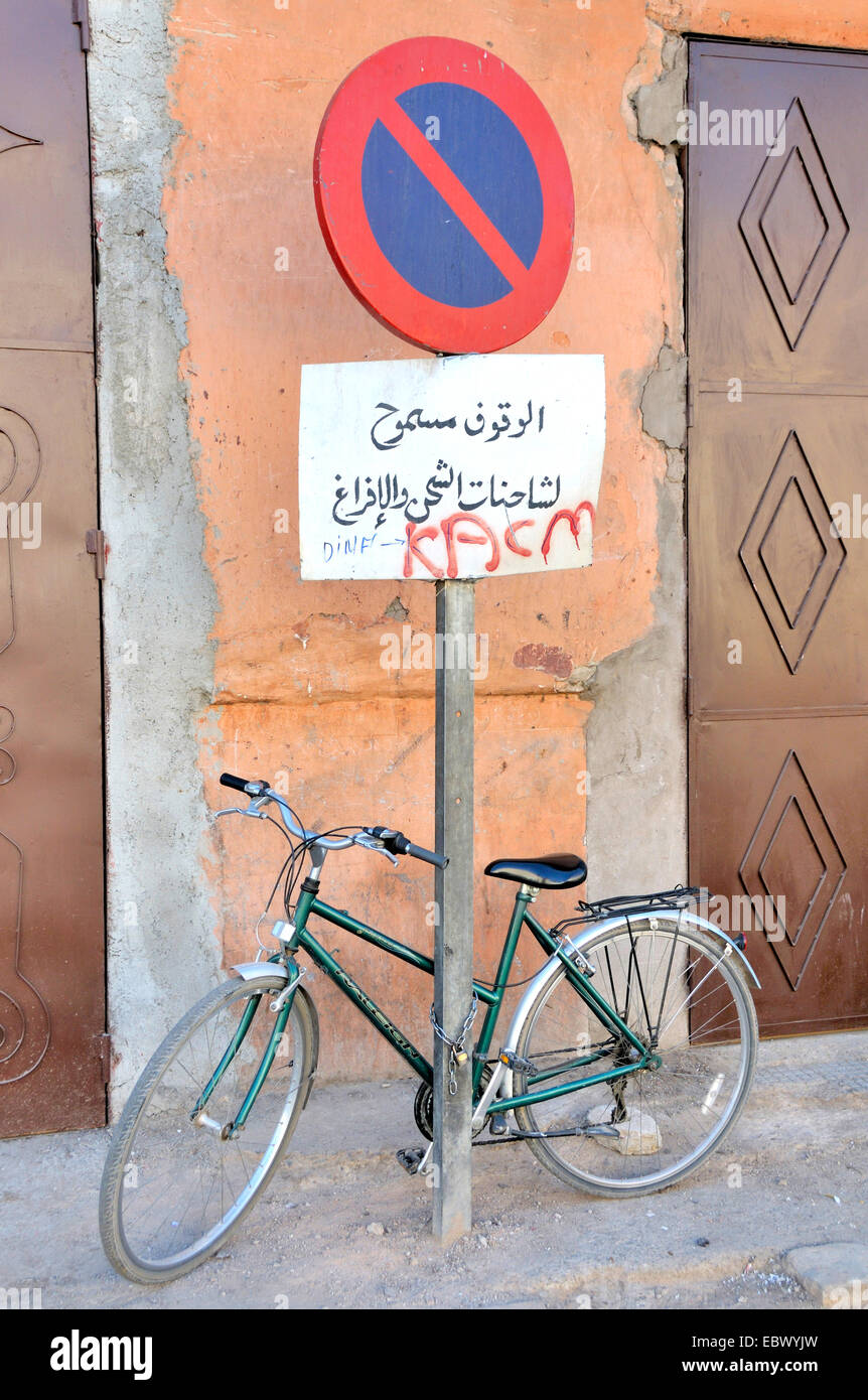 bicycle chained up at no parking sign, Morocco, Marrakesh Stock Photo
