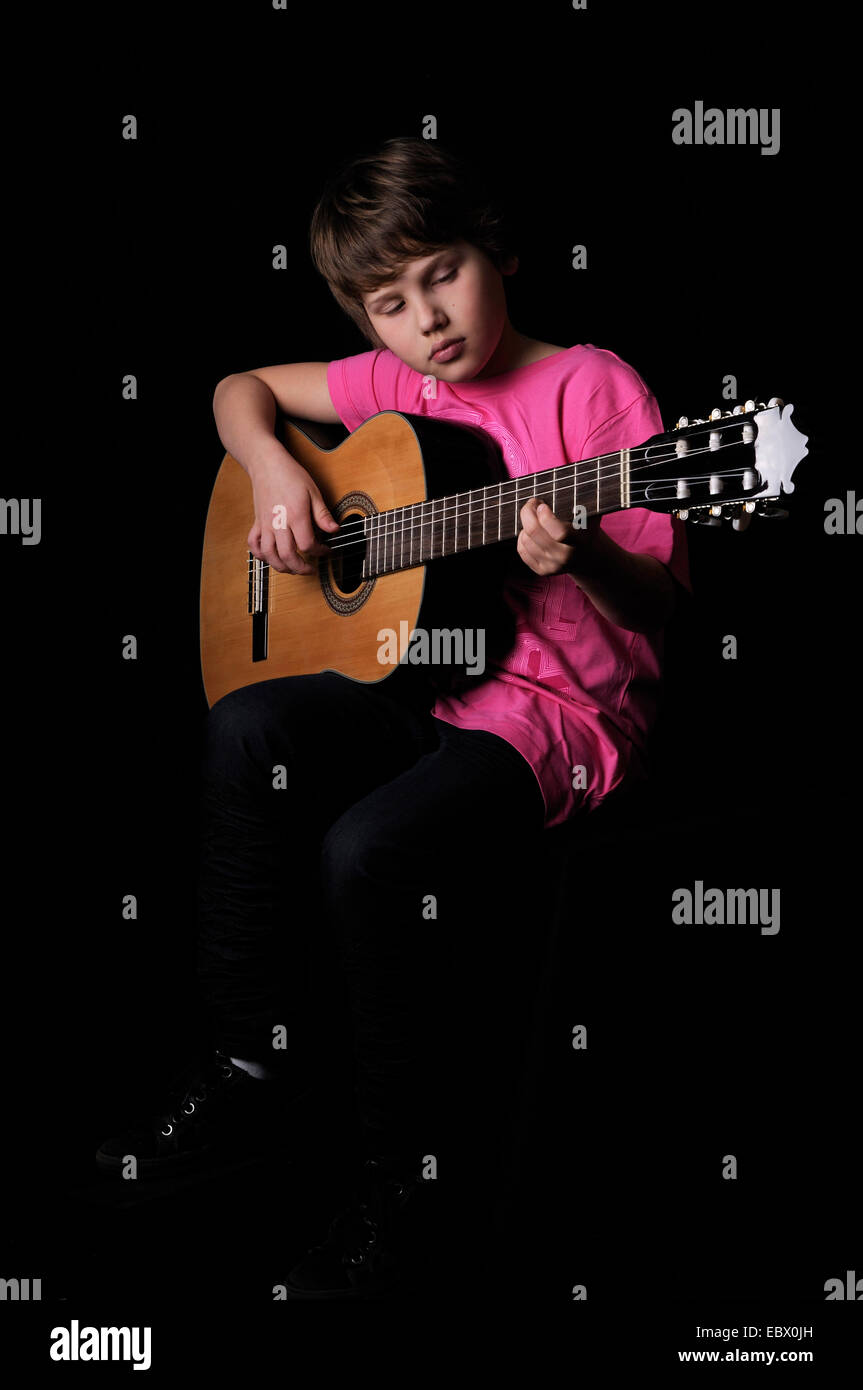 boy playing guitar, Germany Stock Photo
