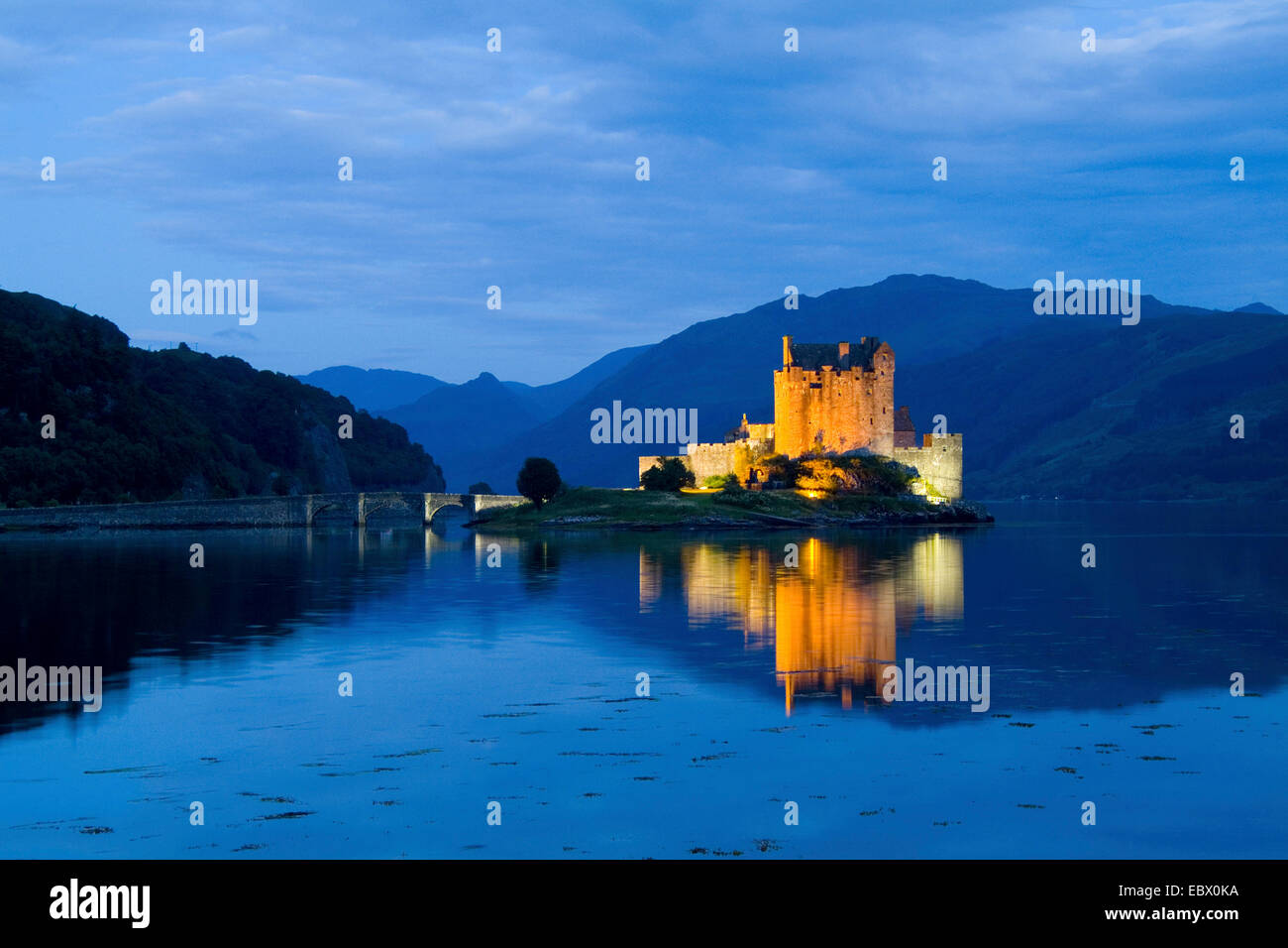 Eileen Donan Castle in Western Dornie with reflections on still beautiful waters at dusk, United Kingdom, Scotland Stock Photo