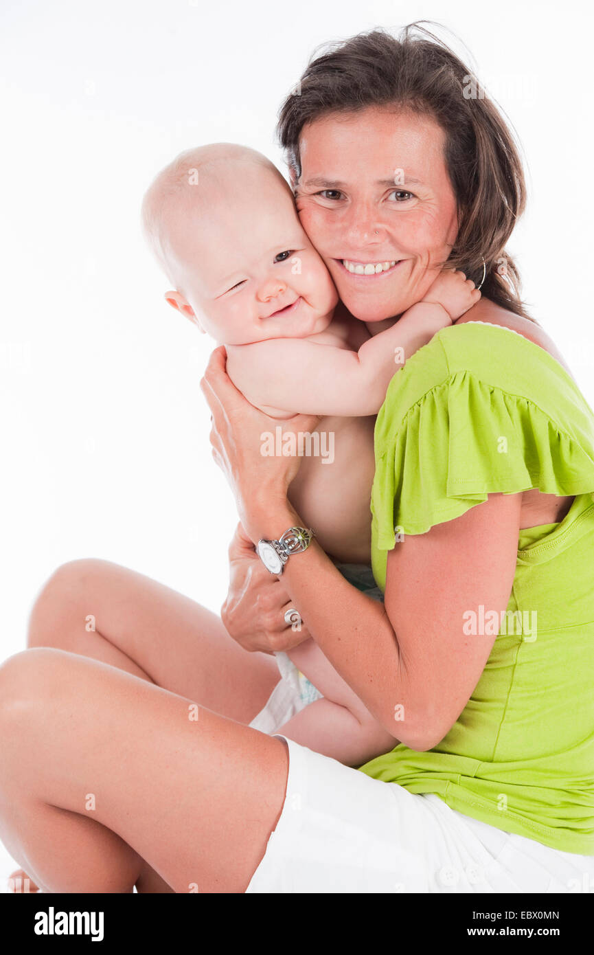10 months old baby in the arms of its mother Stock Photo