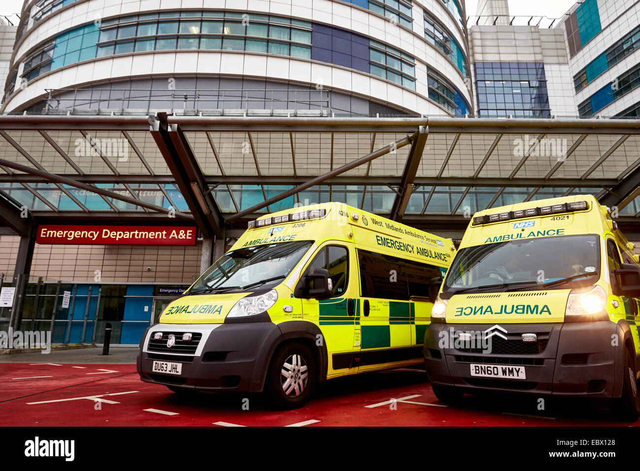 NHS Ambulances wait outside the QE Hospital Birmingham Accident and Emergency department or A&E dept. West Midlands Ambulance. Stock Photo