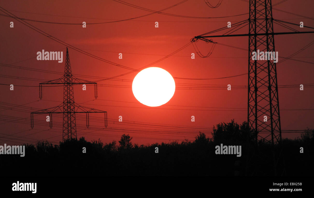 power poles in front of sunset, Germany, NRW, Bottrop Stock Photo