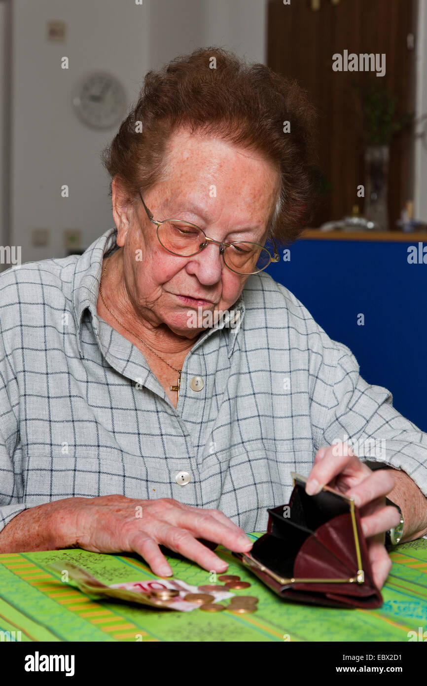 old woman counts her money Stock Photo