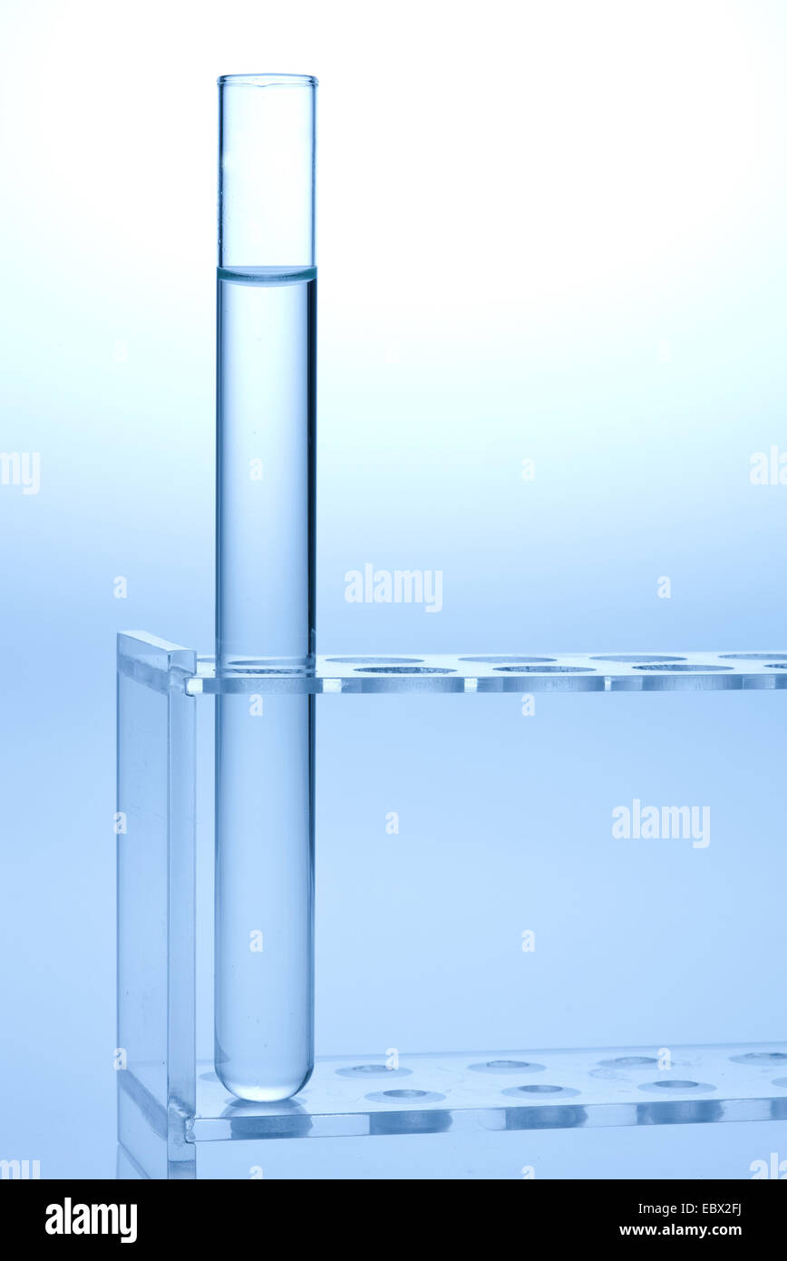 single test tube filled with colourless liquid standing in a test tube rack Stock Photo