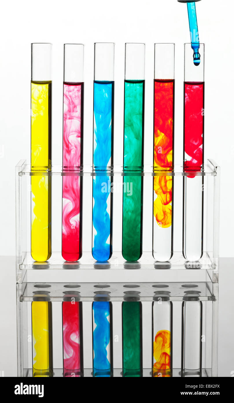 row of test tubes with multicoloured liquids standing in a test tube
