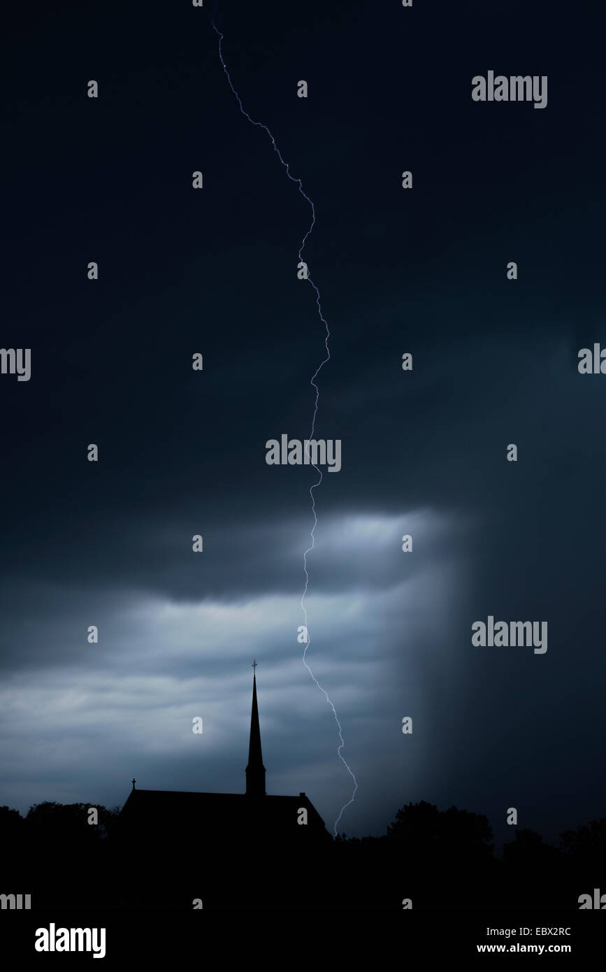 Lightning bolt over church and sky filled with rain and storm clouds. Vadstena abbey, Sweden