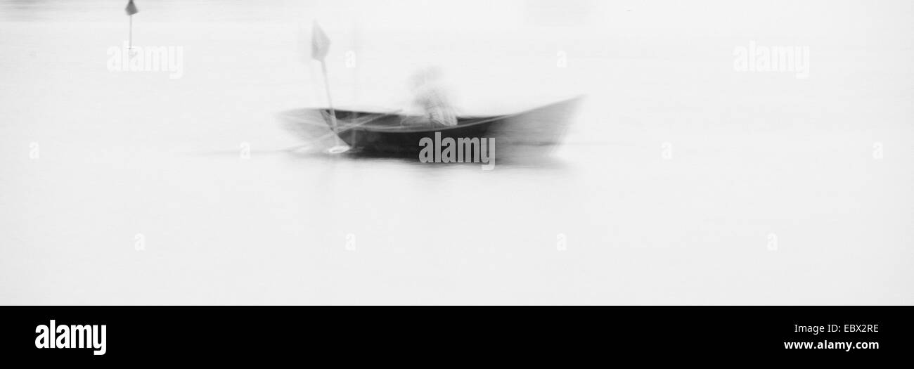 Man in rowboat on lake in Sweden, blurred motion. Stock Photo