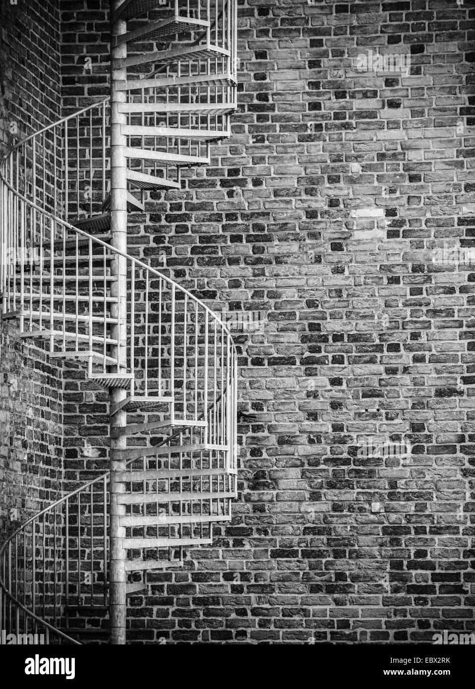 Spiral staircase and brick wall Stock Photo