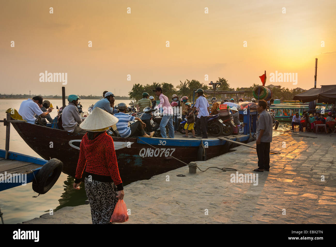 Workers returning home in Hoi An Vietnam at sunset Stock Photo