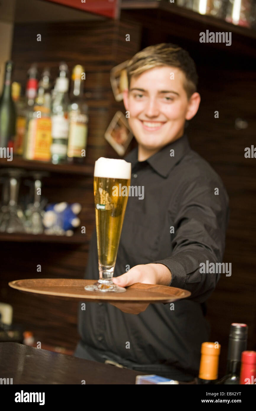 waiter serves beer on a tablet Stock Photo