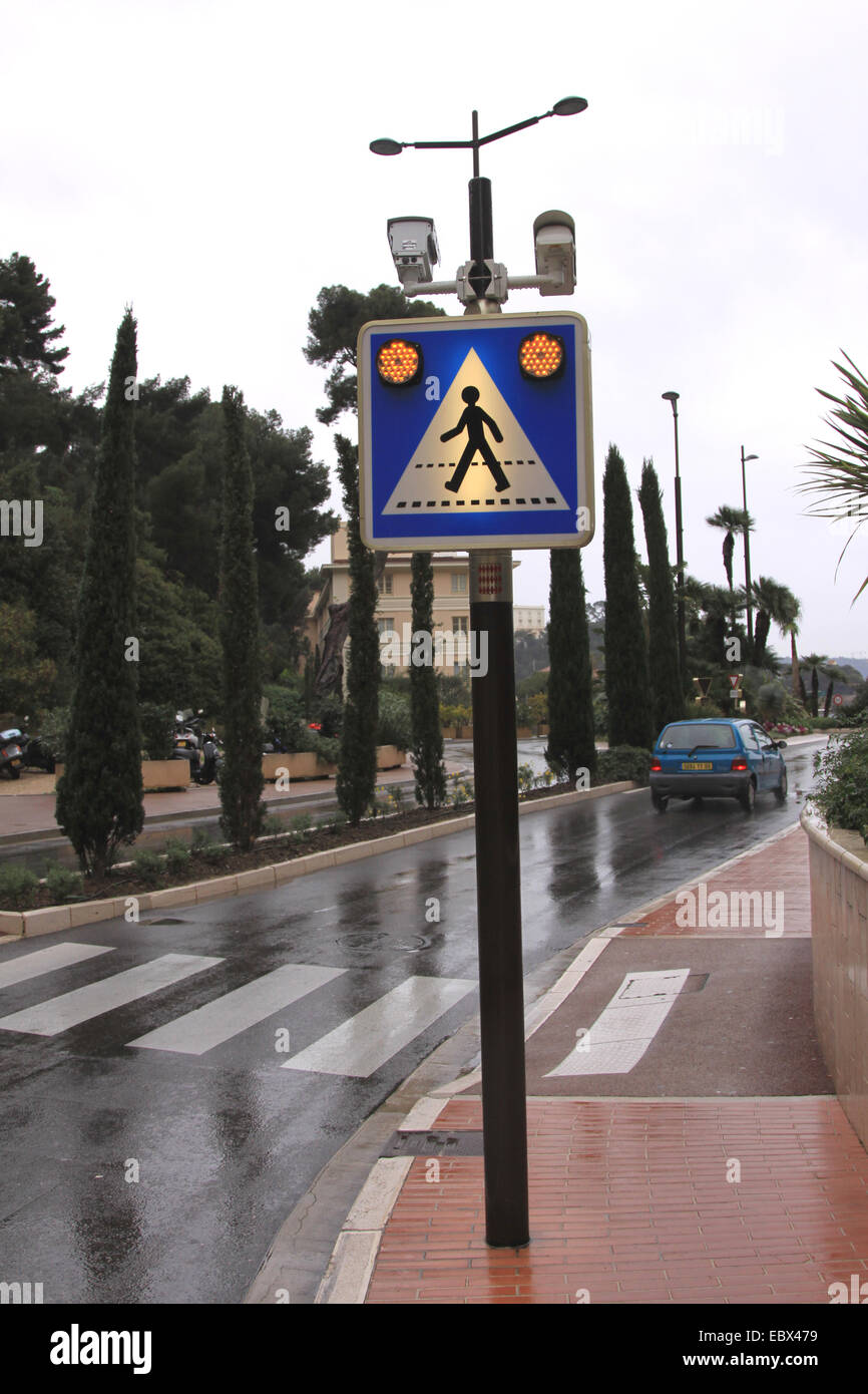 illuminated road sign with warning lights and camera directed traffic control, Monaco, Monte Carlo Stock Photo