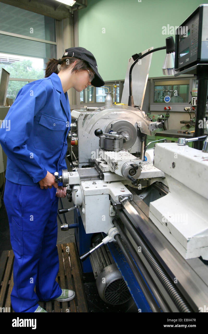 female apprentice working with machines Stock Photo