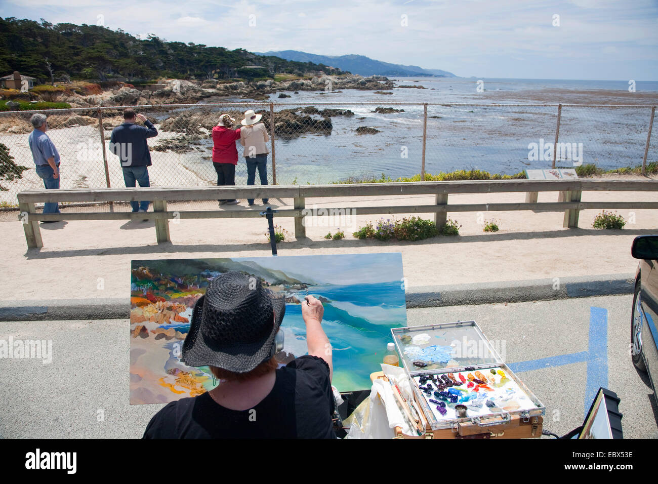 female painter sitting in bay at 17-Mile-Drive, painting, USA, California, 17-Mile-Drive Stock Photo