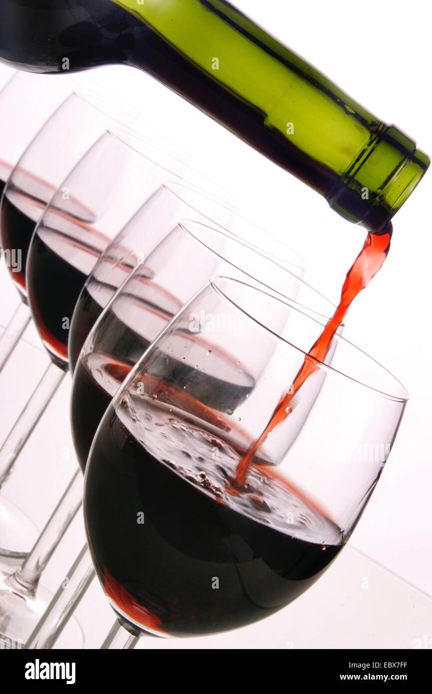 red wine pouring in glasses Stock Photo