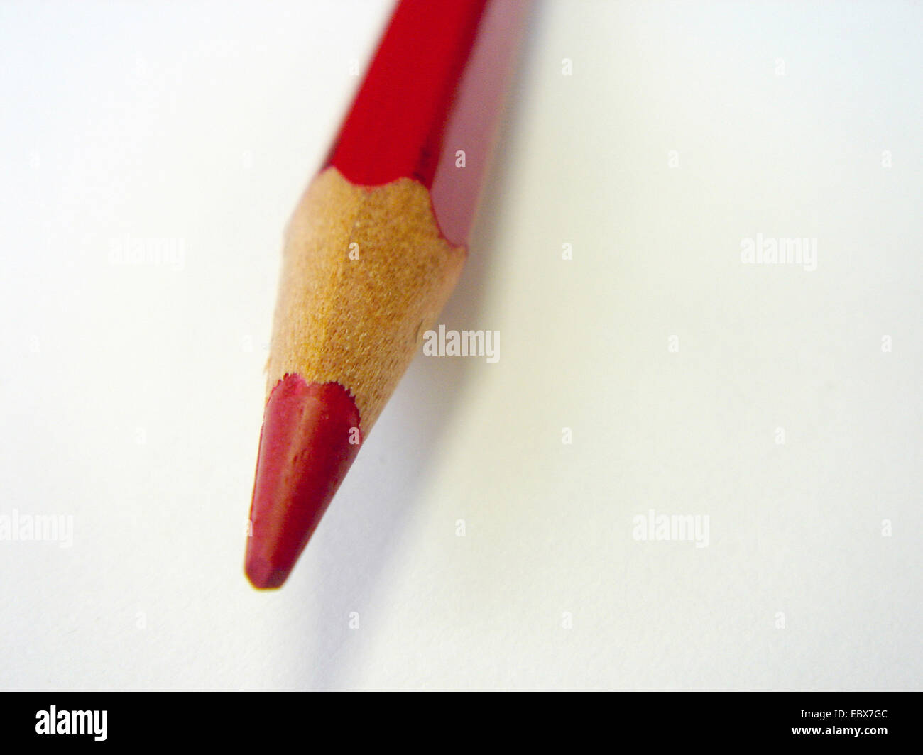red pencil on a blank white sheet of paper Stock Photo