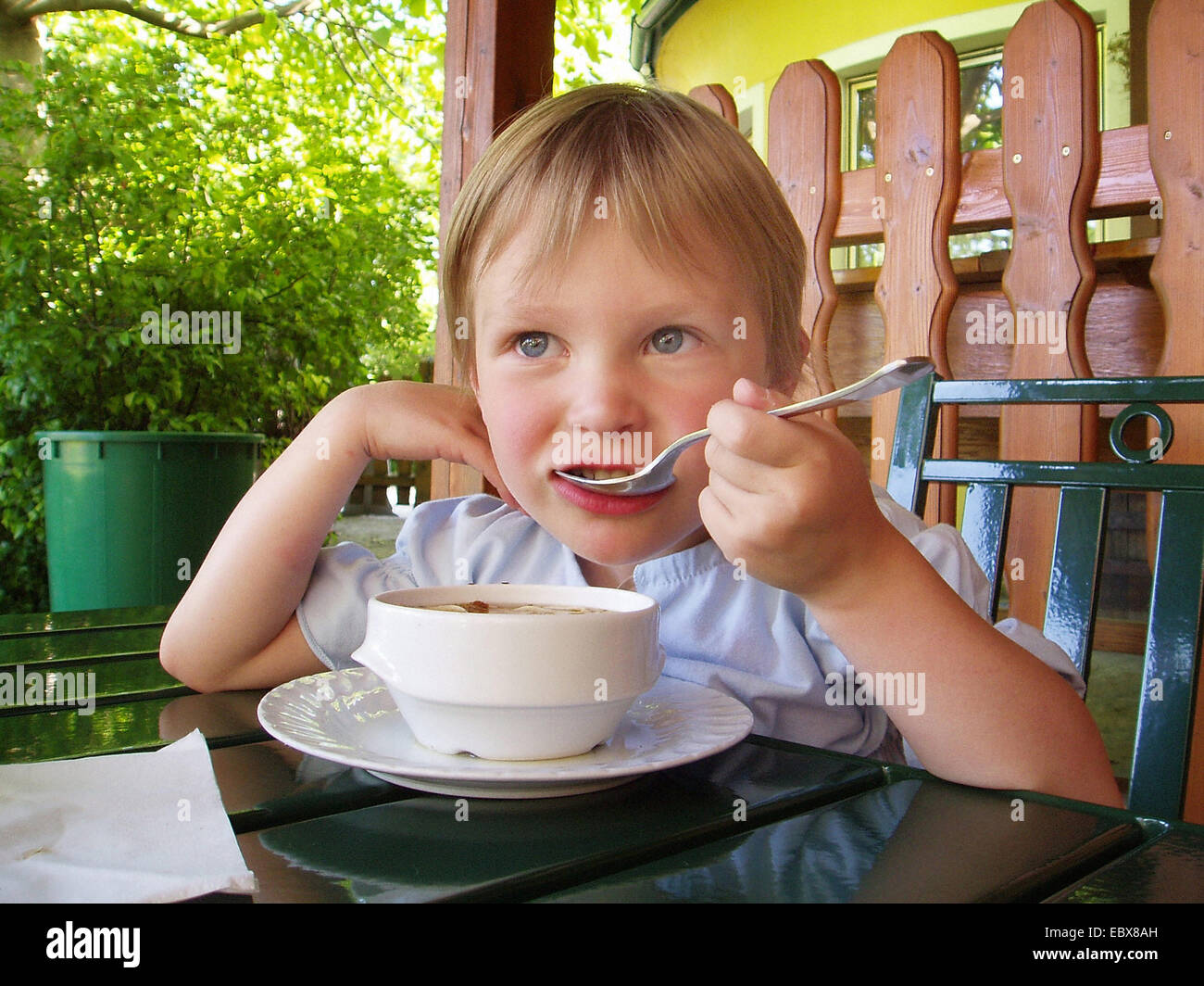 little girl is eating soup Stock Photo