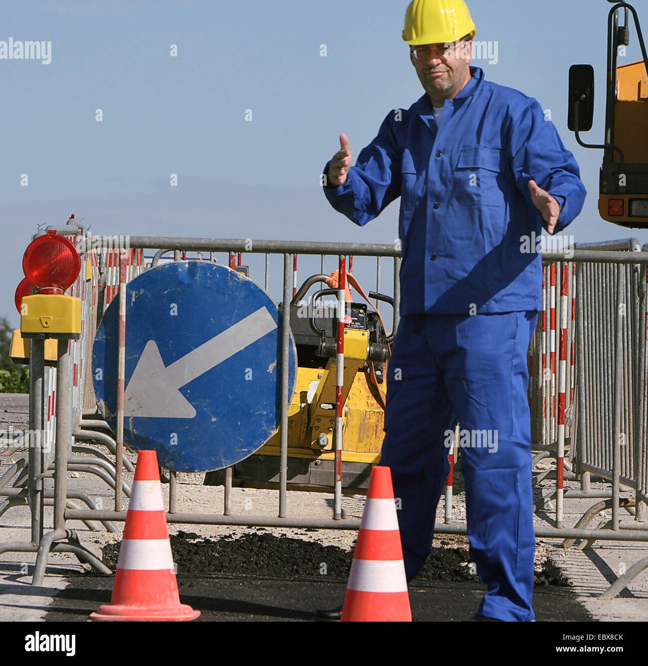 construction worker puts up streetbuilding Stock Photo
