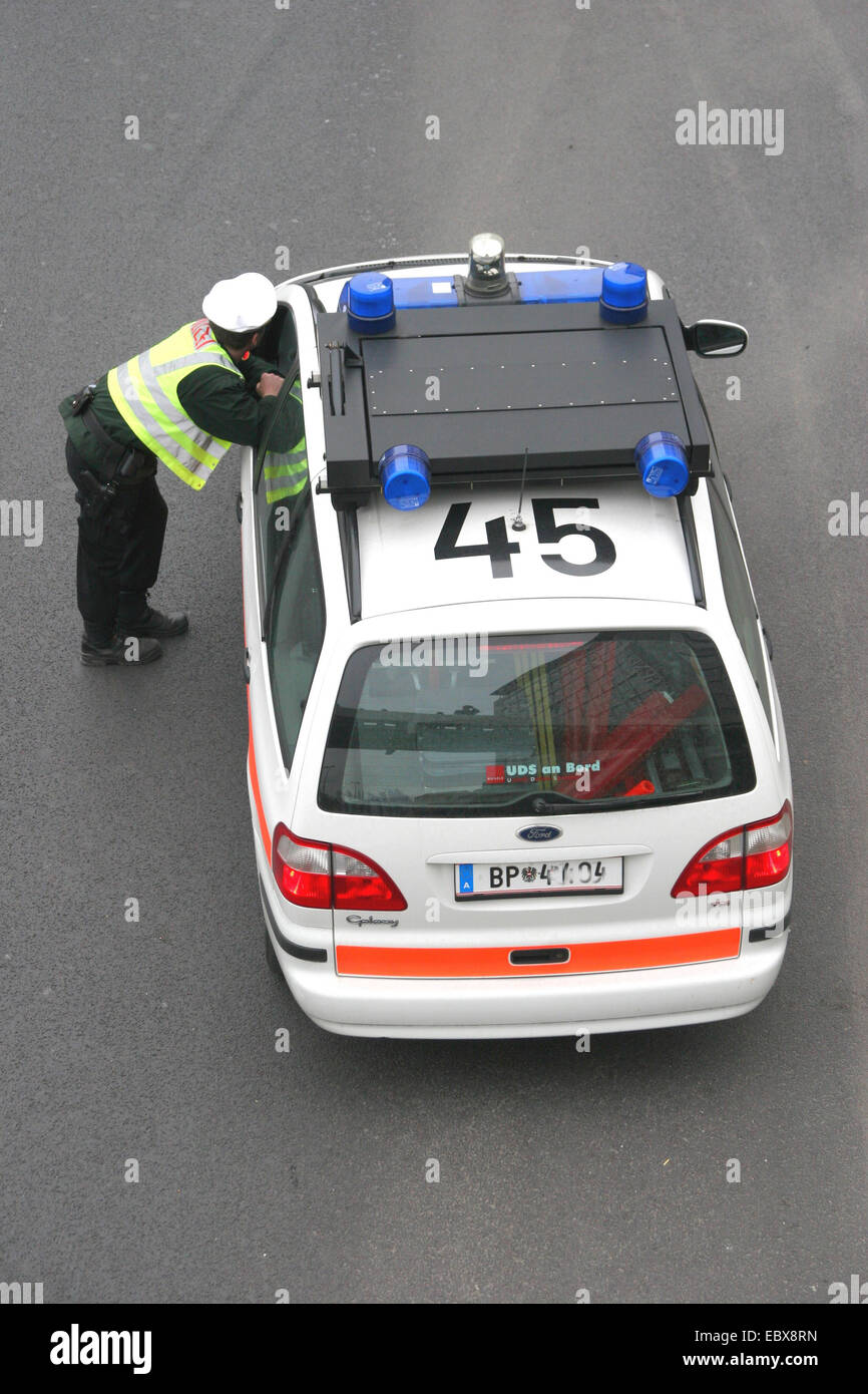policeman standing at austrian police car Stock Photo