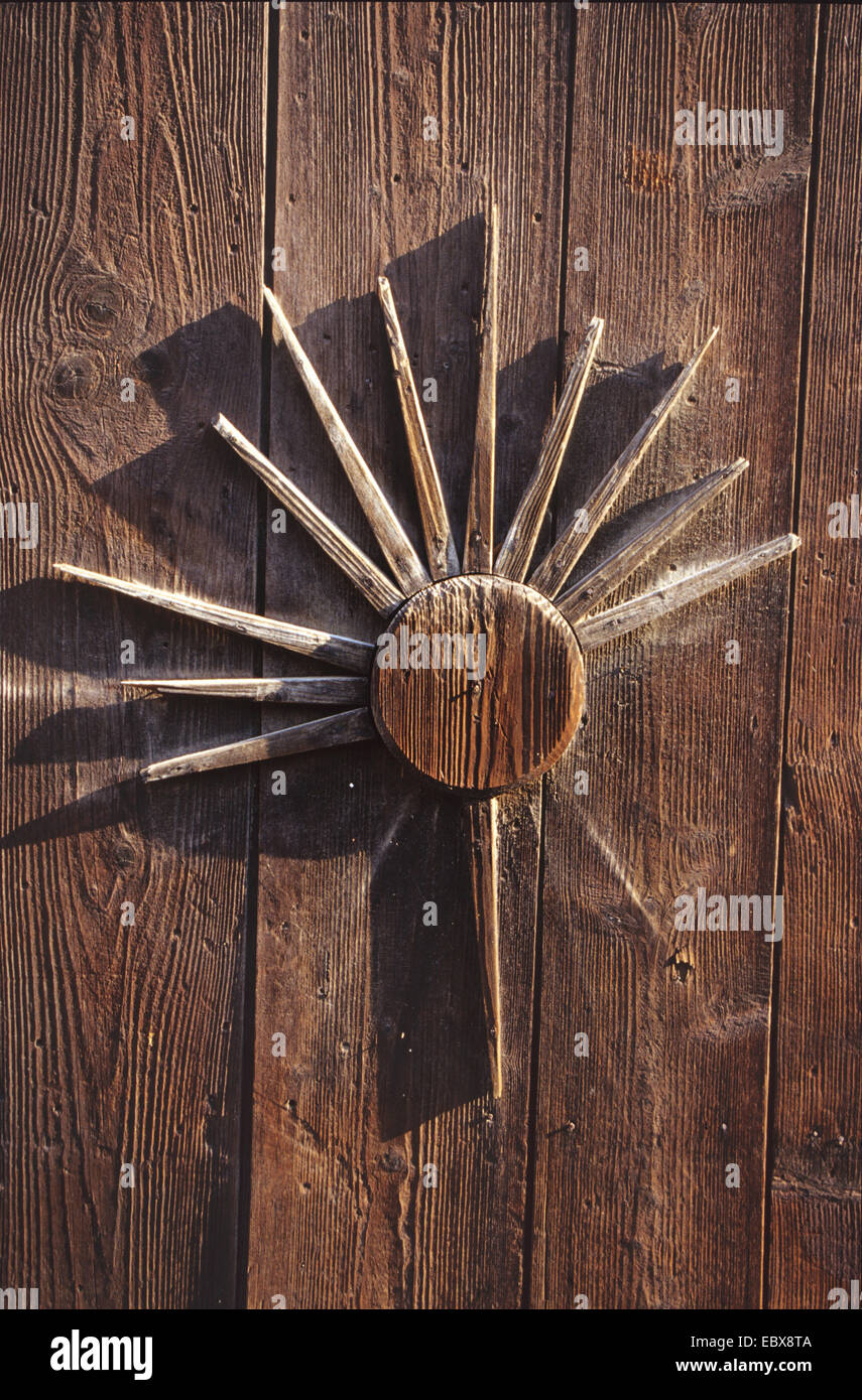 wooden door with symbol of sun Stock Photo